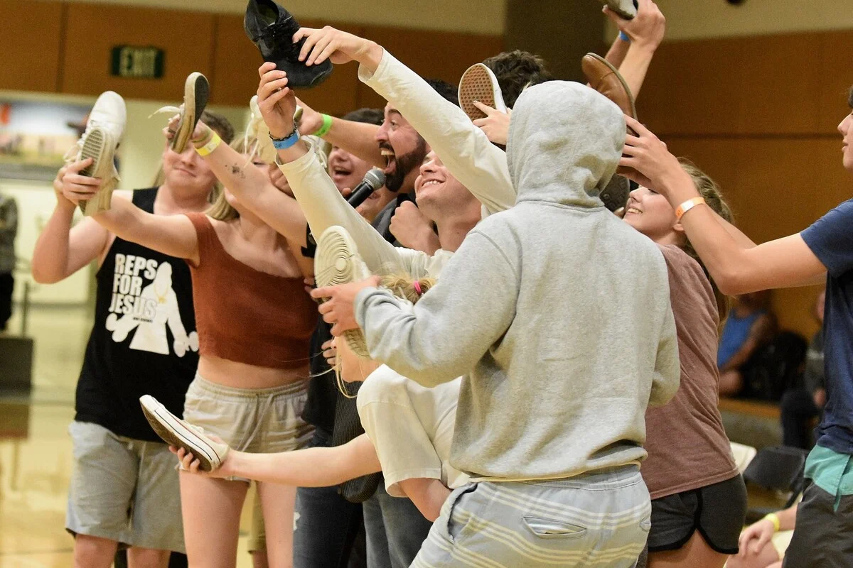 Students performing during a comedy hypnosis assembly